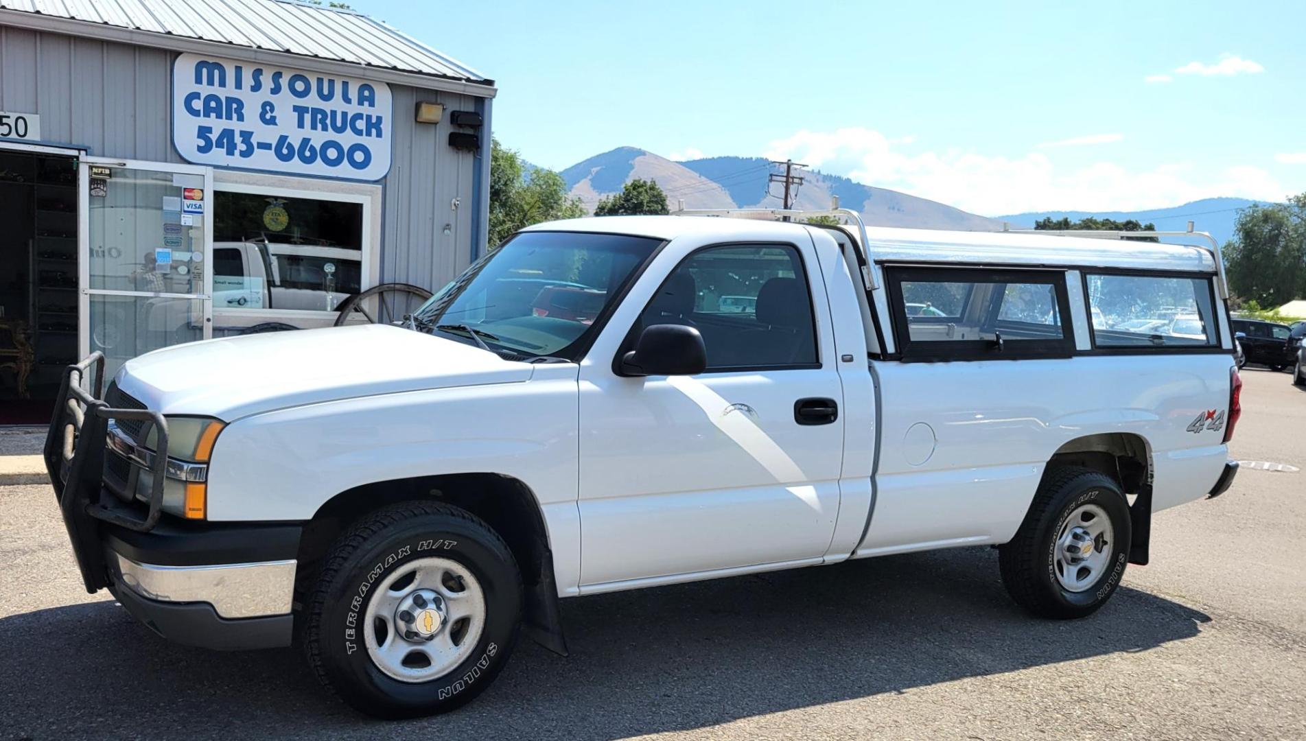 2004 White /Black Chevrolet Silverado 1500 Long Bed 4WD (1GCEK14V04Z) with an 4.8L V8 OHV 16V engine, 5 speed manual transmission, located at 450 N Russell, Missoula, MT, 59801, (406) 543-6600, 46.874496, -114.017433 - Solid 2 Owner 4WD Pickup. Single Cab Long Box. 4.8L V8 Engine. 5 Speed Manual Transmission. Aluminum Topper. Air Conditioning. AM FM Radio. Good Tires. Financing is not available. - Photo#0