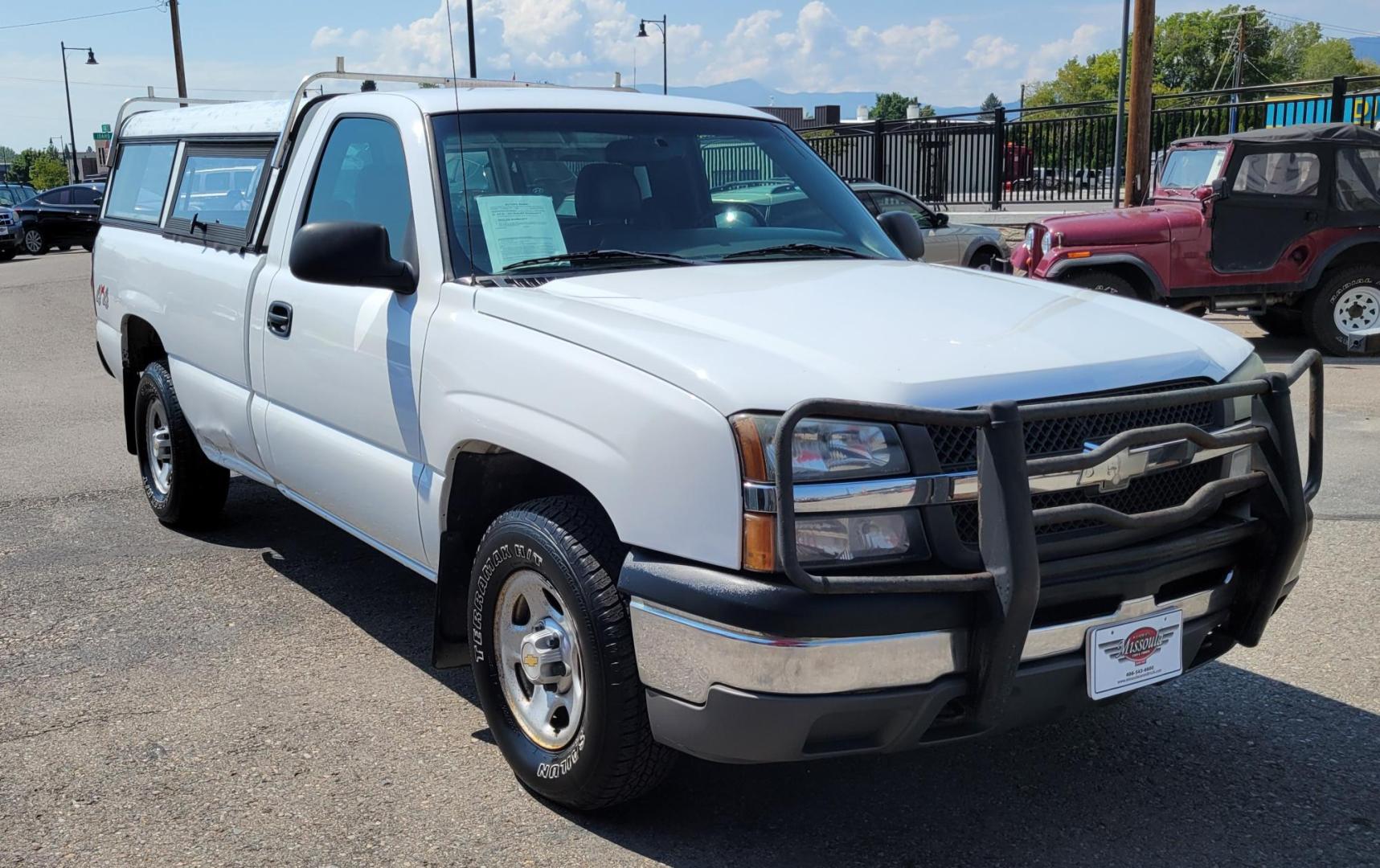 2004 White /Black Chevrolet Silverado 1500 Long Bed 4WD (1GCEK14V04Z) with an 4.8L V8 OHV 16V engine, 5 speed manual transmission, located at 450 N Russell, Missoula, MT, 59801, (406) 543-6600, 46.874496, -114.017433 - Solid 2 Owner 4WD Pickup. Single Cab Long Box. 4.8L V8 Engine. 5 Speed Manual Transmission. Aluminum Topper. Air Conditioning. AM FM Radio. Good Tires. Financing is not available. - Photo#3