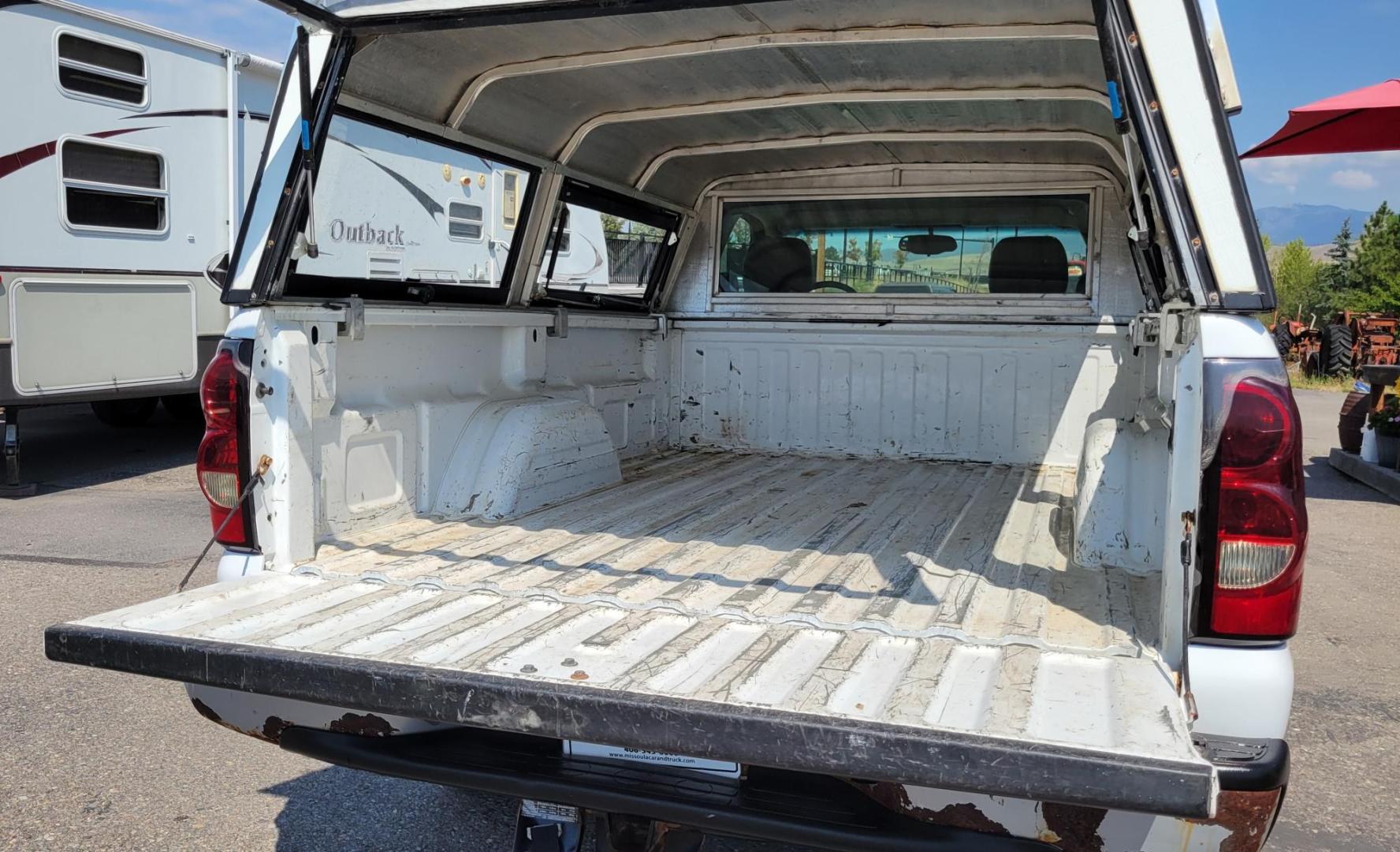 2004 White /Black Chevrolet Silverado 1500 Long Bed 4WD (1GCEK14V04Z) with an 4.8L V8 OHV 16V engine, 5 speed manual transmission, located at 450 N Russell, Missoula, MT, 59801, (406) 543-6600, 46.874496, -114.017433 - Solid 2 Owner 4WD Pickup. Single Cab Long Box. 4.8L V8 Engine. 5 Speed Manual Transmission. Aluminum Topper. Air Conditioning. AM FM Radio. Good Tires. Financing is not available. - Photo#8