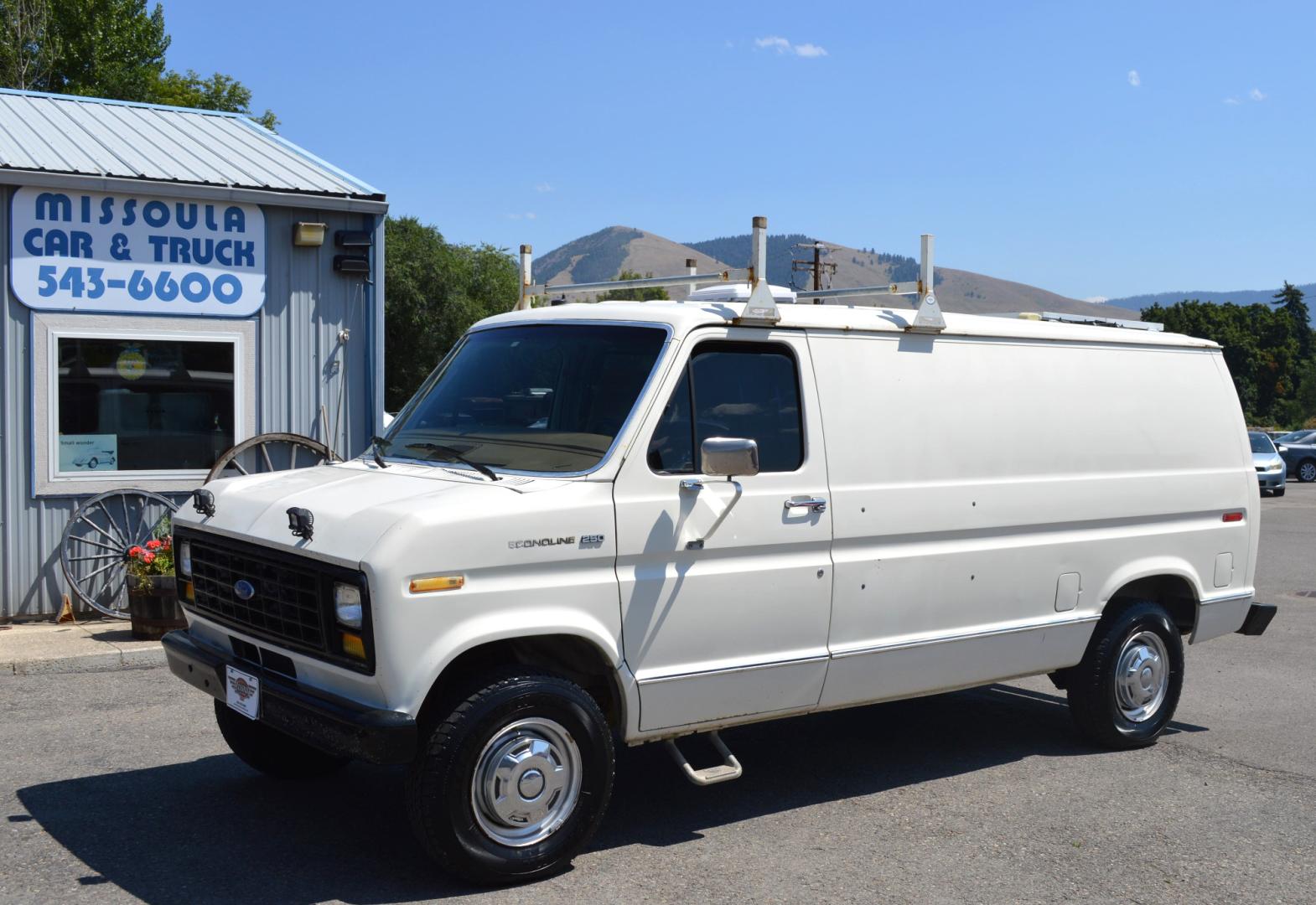 1990 White /Black Ford Econoline E250 (1FTFE24H6LH) with an 5.8L V8 OHV 16V engine, 4-Speed Automatic Overdrive transmission, located at 450 N Russell, Missoula, MT, 59801, (406) 543-6600, 46.874496, -114.017433 - Converted 3/4 Ton Ford Van. Has solar panels on top with a converter for power inside. Had a fold out bed. Comes with a sink that you hook to a 5 gallon water jug. Van Runs great. This vehicle is more then 20 years old and is not eligible for lending through our finance companies. - Photo#0