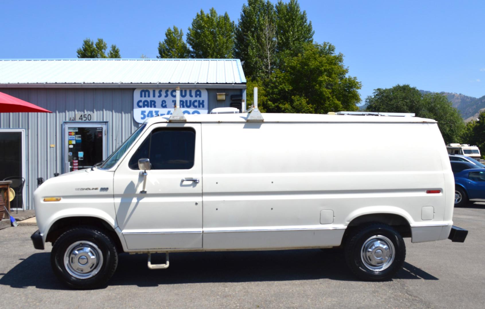 1990 White /Black Ford Econoline E250 (1FTFE24H6LH) with an 5.8L V8 OHV 16V engine, 4-Speed Automatic Overdrive transmission, located at 450 N Russell, Missoula, MT, 59801, (406) 543-6600, 46.874496, -114.017433 - Converted 3/4 Ton Ford Van. Has solar panels on top with a converter for power inside. Had a fold out bed. Comes with a sink that you hook to a 5 gallon water jug. Van Runs great. This vehicle is more then 20 years old and is not eligible for lending through our finance companies. - Photo#1