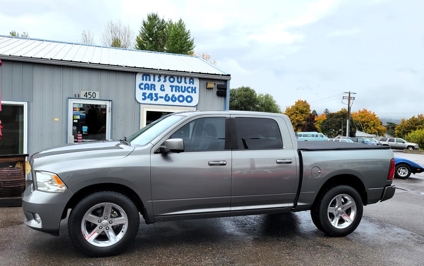 2011 Grey /Black Dodge Ram 1500 ST Crew Cab 4WD (1D7RV1CTXBS) with an 5.7L V8 OHV 16V engine, 5-Speed Automatic transmission, located at 450 N Russell, Missoula, MT, 59801, (406) 543-6600, 46.874496, -114.017433 - Really Nice Truck. Hemi. 4 Wheel Drive. 5 Speed Automatic Transmission. Power Drivers Seat. Air. Cruise. Tilt. AM FM CD Player. Satellite Radio. Power Windows and Locks. Tonneau Cover. Towing. - Photo#0