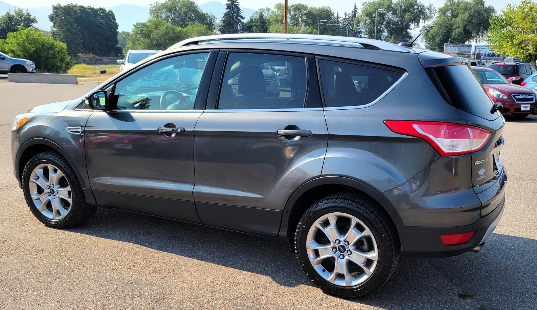 2016 Grey /Black Ford Escape Titanium 4WD (1FMCU9J91GU) with an 2.0L L4 engine, 6 Speed Auto transmission, located at 450 N Russell, Missoula, MT, 59801, (406) 543-6600, 46.874496, -114.017433 - Nice Little 4WD SUV. 2.0L L4 Engine. 6 Speed Automatic Transmission. Heated Seats. Power Lift Gate. Bluetooth. Backup Camera. Touch Screen. AM FM CD. Power Drivers Seat. Fog Lights. Roof Rack Rails. Remote Start. Weather Tech Floor Liners. - Photo#1