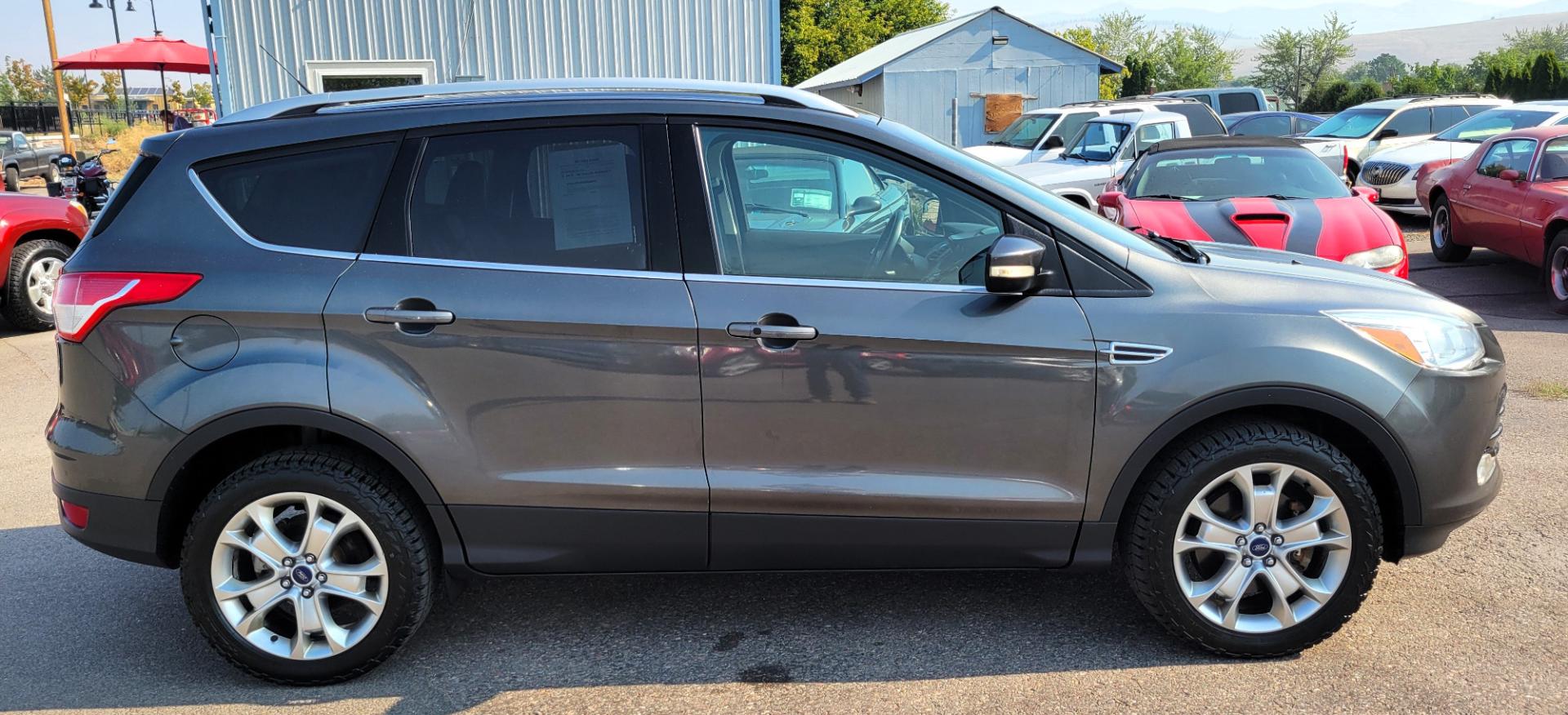 2016 Grey /Black Ford Escape Titanium 4WD (1FMCU9J91GU) with an 2.0L L4 engine, 6 Speed Auto transmission, located at 450 N Russell, Missoula, MT, 59801, (406) 543-6600, 46.874496, -114.017433 - Nice Little 4WD SUV. 2.0L L4 Engine. 6 Speed Automatic Transmission. Heated Seats. Power Lift Gate. Bluetooth. Backup Camera. Touch Screen. AM FM CD. Power Drivers Seat. Fog Lights. Roof Rack Rails. Remote Start. Weather Tech Floor Liners. - Photo#5