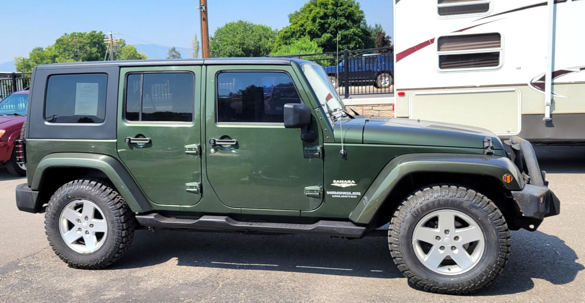 2007 Green /Black Jeep Wrangler Unlimited Sahara 4WD (1J4GA59137L) with an 3.8L V6 OHV 12V engine, Automatic transmission, located at 450 N Russell, Missoula, MT, 59801, (406) 543-6600, 46.874496, -114.017433 - 4WD. 4 Door Wrangler. Removable Hardtop. 3.8L V6 Engine. Automatic Transmission. Power Windows and Locks. Air. Cruise. Tilt. AM FM CD. New Tires. - Photo#4