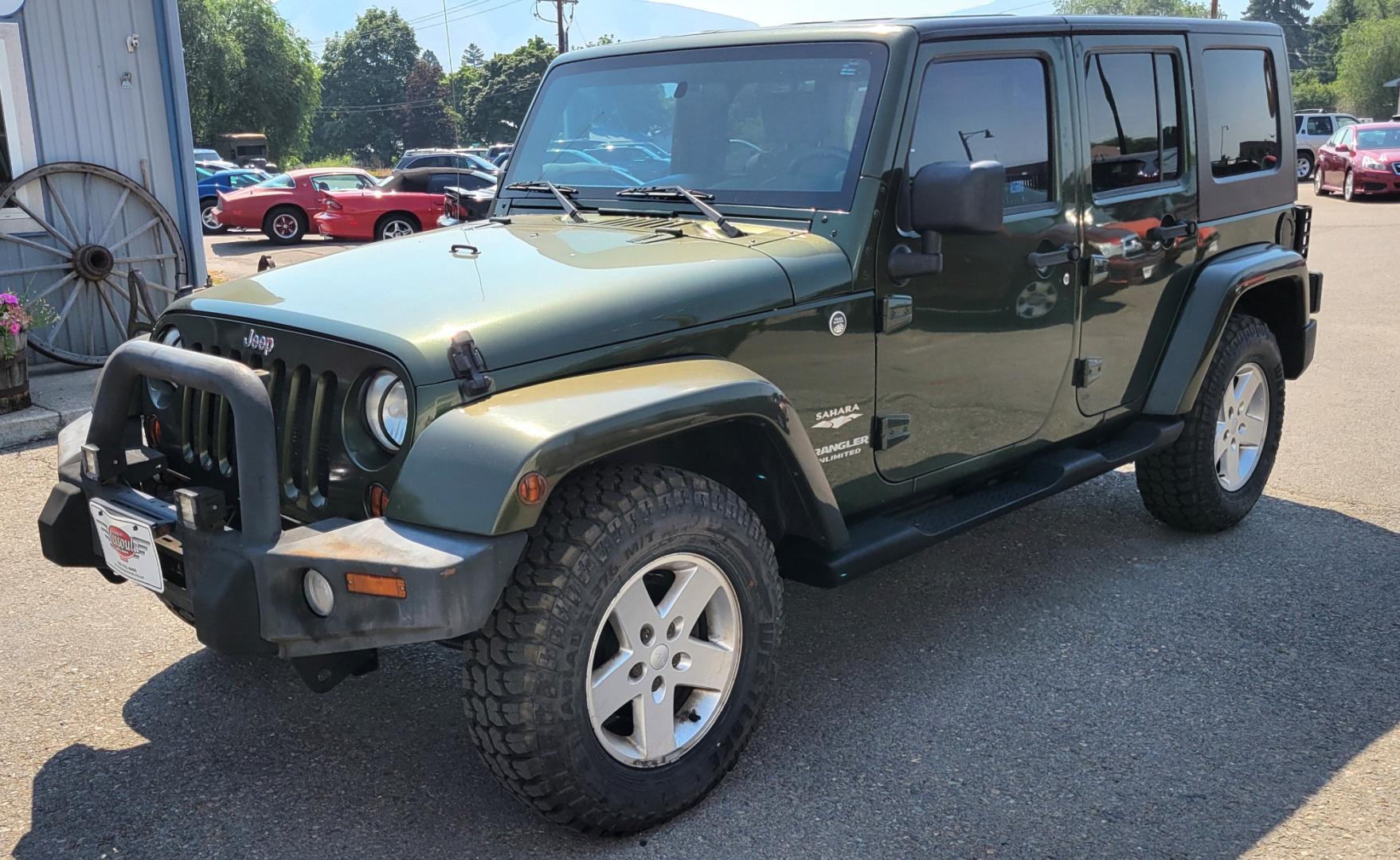 2007 Green /Black Jeep Wrangler Unlimited Sahara 4WD (1J4GA59137L) with an 3.8L V6 OHV 12V engine, Automatic transmission, located at 450 N Russell, Missoula, MT, 59801, (406) 543-6600, 46.874496, -114.017433 - 4WD. 4 Door Wrangler. Removable Hardtop. 3.8L V6 Engine. Automatic Transmission. Power Windows and Locks. Air. Cruise. Tilt. AM FM CD. New Tires. - Photo#1