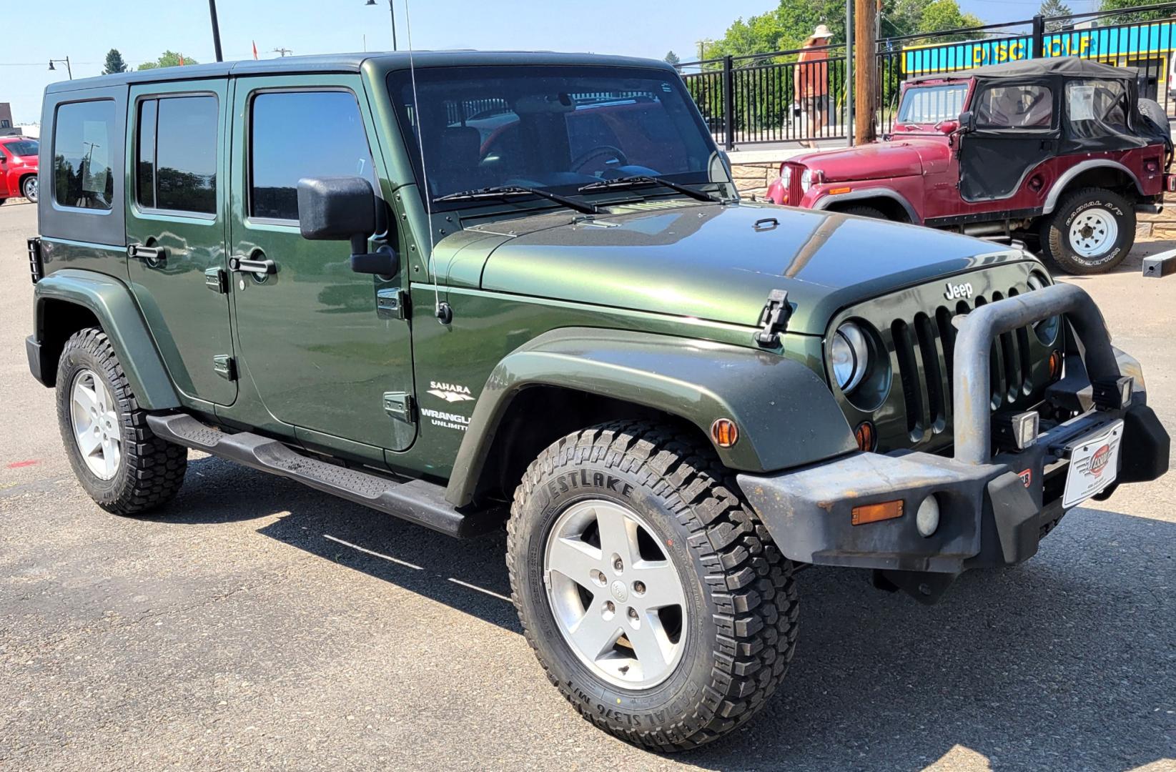 2007 Green /Black Jeep Wrangler Unlimited Sahara 4WD (1J4GA59137L) with an 3.8L V6 OHV 12V engine, Automatic transmission, located at 450 N Russell, Missoula, MT, 59801, (406) 543-6600, 46.874496, -114.017433 - 4WD. 4 Door Wrangler. Removable Hardtop. 3.8L V6 Engine. Automatic Transmission. Power Windows and Locks. Air. Cruise. Tilt. AM FM CD. New Tires. - Photo#3