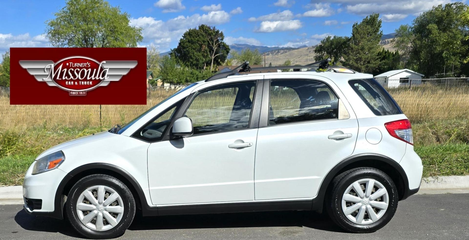 2013 White /Black Suzuki SX4 Crossover Premium AWD (JS2YB5A32D6) with an 2.0L L4 DOHC 16V engine, 6 Speed Manual transmission, located at 450 N Russell, Missoula, MT, 59801, (406) 543-6600, 46.874496, -114.017433 - Cute Little economy AWD in excellent Condition. 2.0L I4 Engine. 6 Speed Manual Transmission. Power Windows and Locks. Air conditioning. One Owner. Clean Carfax. - Photo#0