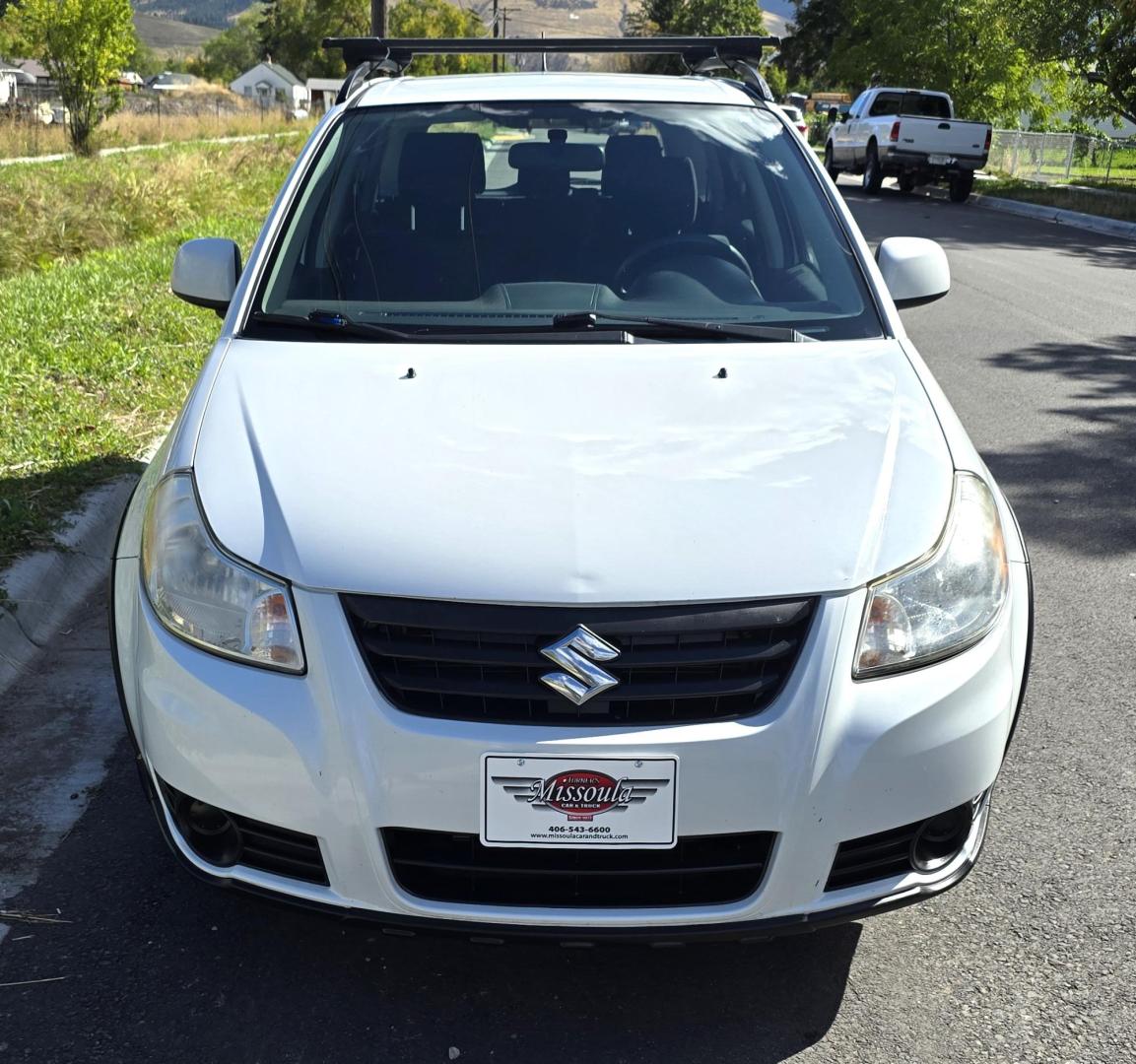 2013 White /Black Suzuki SX4 Crossover Premium AWD (JS2YB5A32D6) with an 2.0L L4 DOHC 16V engine, 6 Speed Manual transmission, located at 450 N Russell, Missoula, MT, 59801, (406) 543-6600, 46.874496, -114.017433 - Cute Little economy AWD in excellent Condition. 2.0L I4 Engine. 6 Speed Manual Transmission. Power Windows and Locks. Air conditioning. One Owner. Clean Carfax. - Photo#1