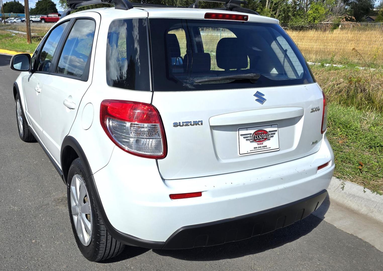 2013 White /Black Suzuki SX4 Crossover Premium AWD (JS2YB5A32D6) with an 2.0L L4 DOHC 16V engine, 6 Speed Manual transmission, located at 450 N Russell, Missoula, MT, 59801, (406) 543-6600, 46.874496, -114.017433 - Cute Little economy AWD in excellent Condition. 2.0L I4 Engine. 6 Speed Manual Transmission. Power Windows and Locks. Air conditioning. One Owner. Clean Carfax. - Photo#7