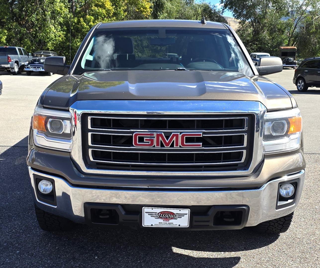 2014 Bronze /Black GMC Sierra 1500 SLE Crew Cab 4WD (3GTU2UEC9EG) with an 5.3L V8 OHV 16V engine, 6-Speed Automatic transmission, located at 450 N Russell, Missoula, MT, 59801, (406) 543-6600, 46.874496, -114.017433 - 1/2 Ton 4WD GMC in Good Condition. Drivers Seats has a small tear. 5.3L V8. Automatic Transmission. Power Drivers Seat. Heated Seats. Navigation. AM FM XM Bluetooth. backup Camera. Tonneau Cover. Towing Package. Beefy Tires. Good fuel economy for it's size. - Photo#4