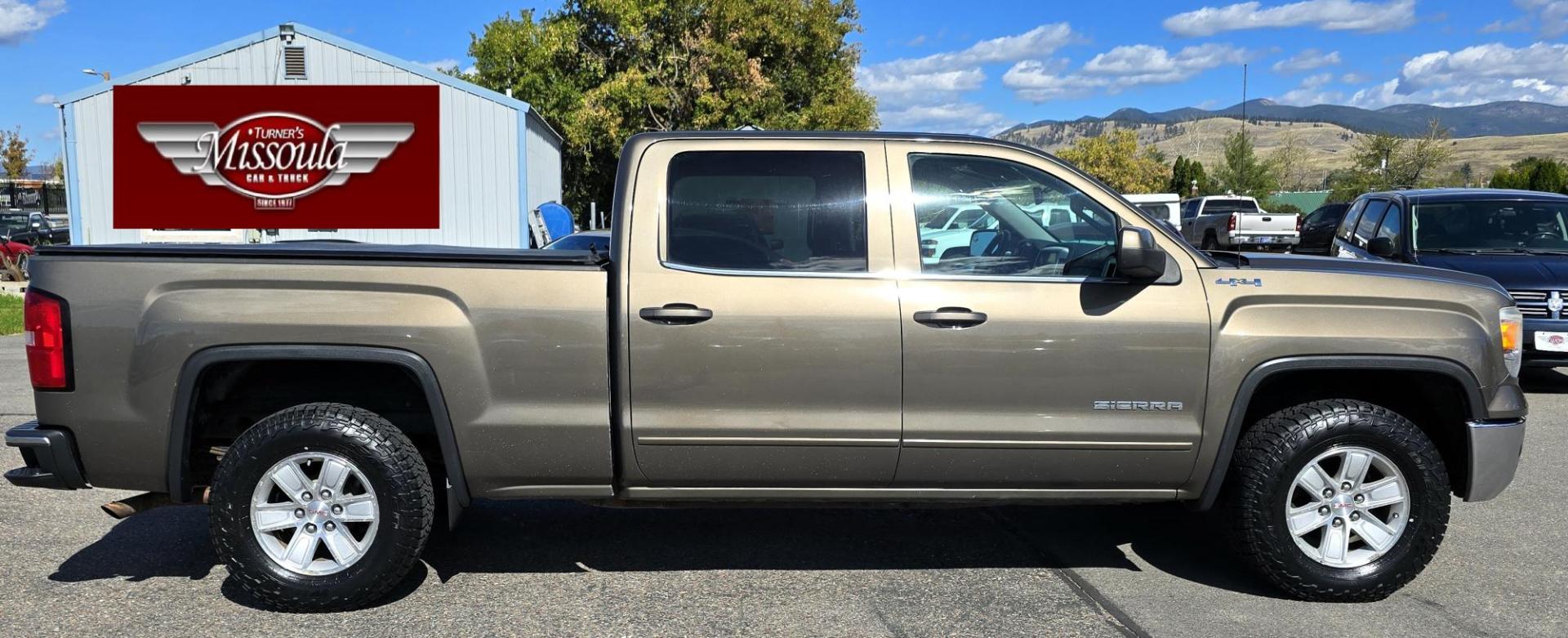 2014 Bronze /Black GMC Sierra 1500 SLE Crew Cab 4WD (3GTU2UEC9EG) with an 5.3L V8 OHV 16V engine, 6-Speed Automatic transmission, located at 450 N Russell, Missoula, MT, 59801, (406) 543-6600, 46.874496, -114.017433 - 1/2 Ton 4WD GMC in Good Condition. Drivers Seats has a small tear. 5.3L V8. Automatic Transmission. Power Drivers Seat. Heated Seats. Navigation. AM FM XM Bluetooth. backup Camera. Tonneau Cover. Towing Package. Beefy Tires. Good fuel economy for it's size. - Photo#1