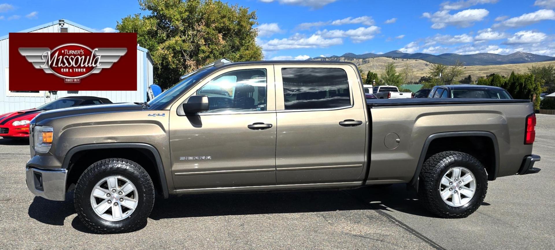 2014 Bronze /Black GMC Sierra 1500 SLE Crew Cab 4WD (3GTU2UEC9EG) with an 5.3L V8 OHV 16V engine, 6-Speed Automatic transmission, located at 450 N Russell, Missoula, MT, 59801, (406) 543-6600, 46.874496, -114.017433 - 1/2 Ton 4WD GMC in Good Condition. Drivers Seats has a small tear. 5.3L V8. Automatic Transmission. Power Drivers Seat. Heated Seats. Navigation. AM FM XM Bluetooth. backup Camera. Tonneau Cover. Towing Package. Beefy Tires. Good fuel economy for it's size. - Photo#2