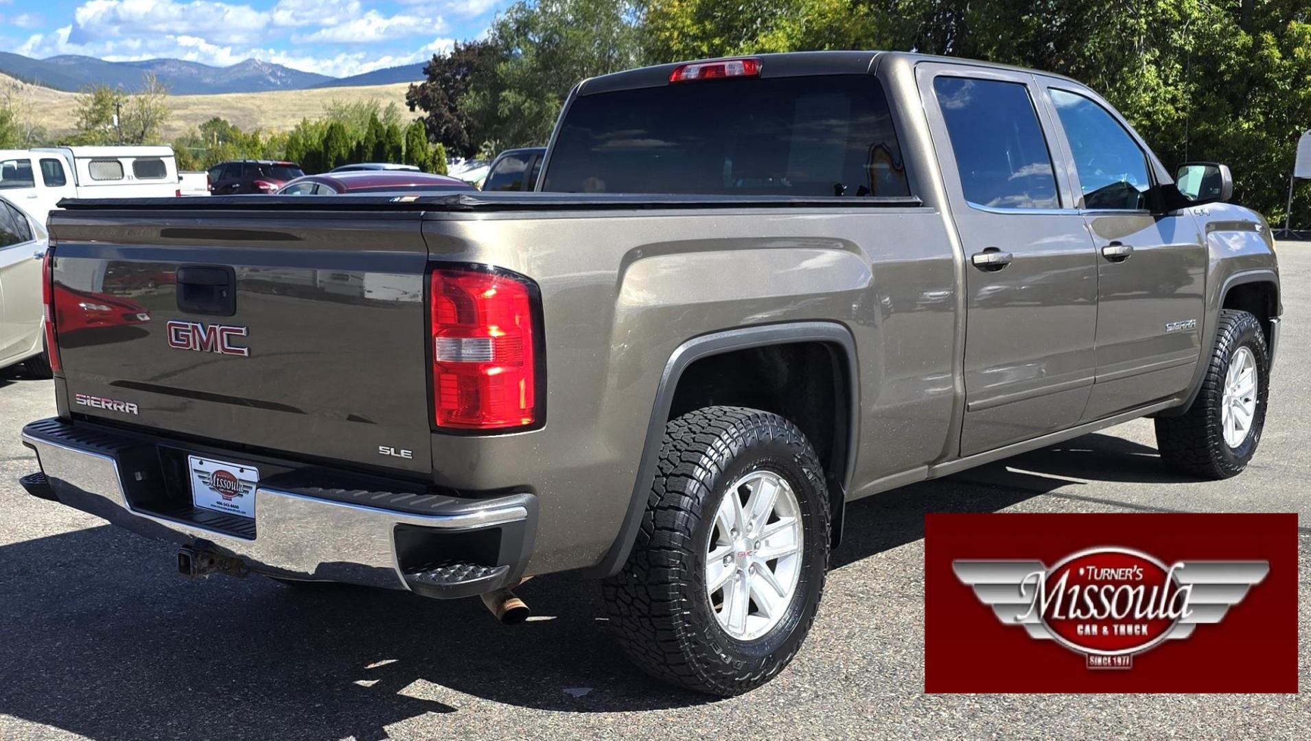 2014 Bronze /Black GMC Sierra 1500 SLE Crew Cab 4WD (3GTU2UEC9EG) with an 5.3L V8 OHV 16V engine, 6-Speed Automatic transmission, located at 450 N Russell, Missoula, MT, 59801, (406) 543-6600, 46.874496, -114.017433 - 1/2 Ton 4WD GMC in Good Condition. Drivers Seats has a small tear. 5.3L V8. Automatic Transmission. Power Drivers Seat. Heated Seats. Navigation. AM FM XM Bluetooth. backup Camera. Tonneau Cover. Towing Package. Beefy Tires. Good fuel economy for it's size. - Photo#3