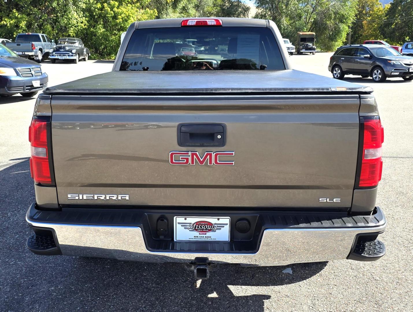 2014 Bronze /Black GMC Sierra 1500 SLE Crew Cab 4WD (3GTU2UEC9EG) with an 5.3L V8 OHV 16V engine, 6-Speed Automatic transmission, located at 450 N Russell, Missoula, MT, 59801, (406) 543-6600, 46.874496, -114.017433 - 1/2 Ton 4WD GMC in Good Condition. Drivers Seats has a small tear. 5.3L V8. Automatic Transmission. Power Drivers Seat. Heated Seats. Navigation. AM FM XM Bluetooth. backup Camera. Tonneau Cover. Towing Package. Beefy Tires. Good fuel economy for it's size. - Photo#5