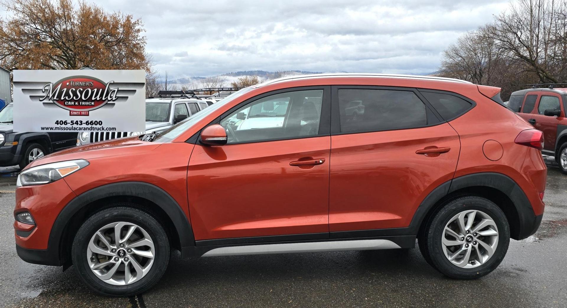 2017 Orange /Black Hyundai Tucson SE w/Preferred Package AWD (KM8J3CA44HU) with an 2.0L L4 DOHC 16V engine, 6A transmission, located at 450 N Russell, Missoula, MT, 59801, (406) 543-6600, 46.874496, -114.017433 - Beautiful Clean AWD SUV. 2.0L I4 Engine. 6 Speed Automatic Transmission. Heated Power Seats. Navigation. Infinity Sound System. AM FM SAT. Bluetooth Audio and Phone. Blindspot Detection. Backup Camera. - Photo#1