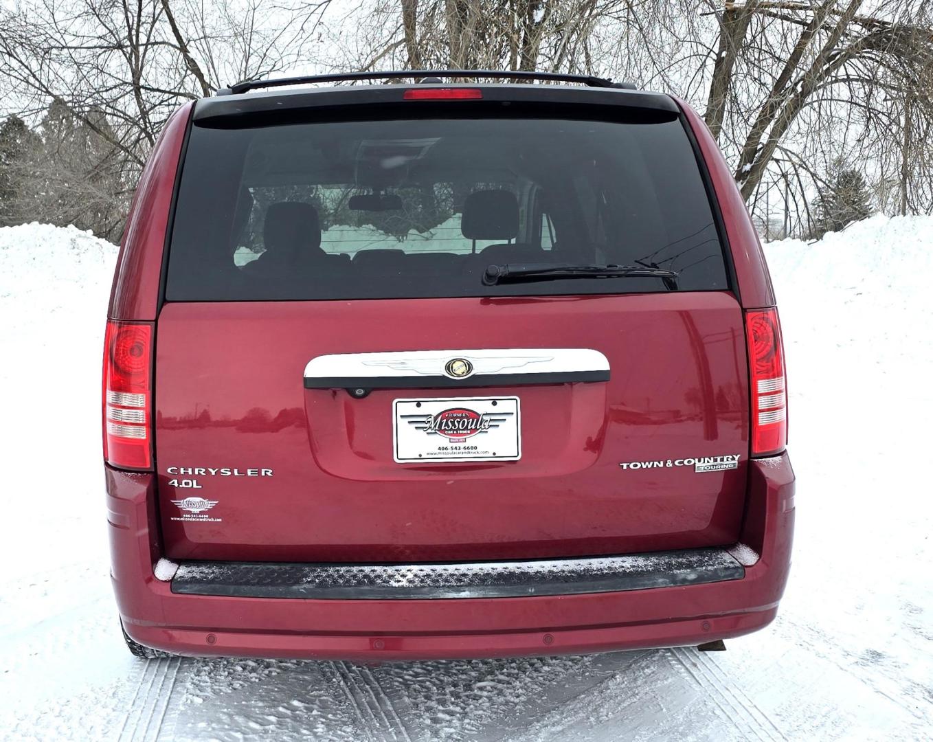 2010 Red /White Chrysler Town & Country Touring Plus (2A4RR8DX4AR) with an 4.0L V6 SOHC 24V engine, 6-Speed Automatic transmission, located at 450 N Russell, Missoula, MT, 59801, (406) 543-6600, 46.874496, -114.017433 - Very Clean Town and Country. 4.0L v6 Engine. Automatic Transmission. Front Wheel Drive. Heated Front Seats. Dual Climate Control. Front and Rear Entertainment. AM FM XM Bluetooth. 3rd Row Seating. Power Rear Doors. Remote start. Excellent Tires. One small dent. Has a "ESP BAS" Light on. Runs Amazing - Photo#5