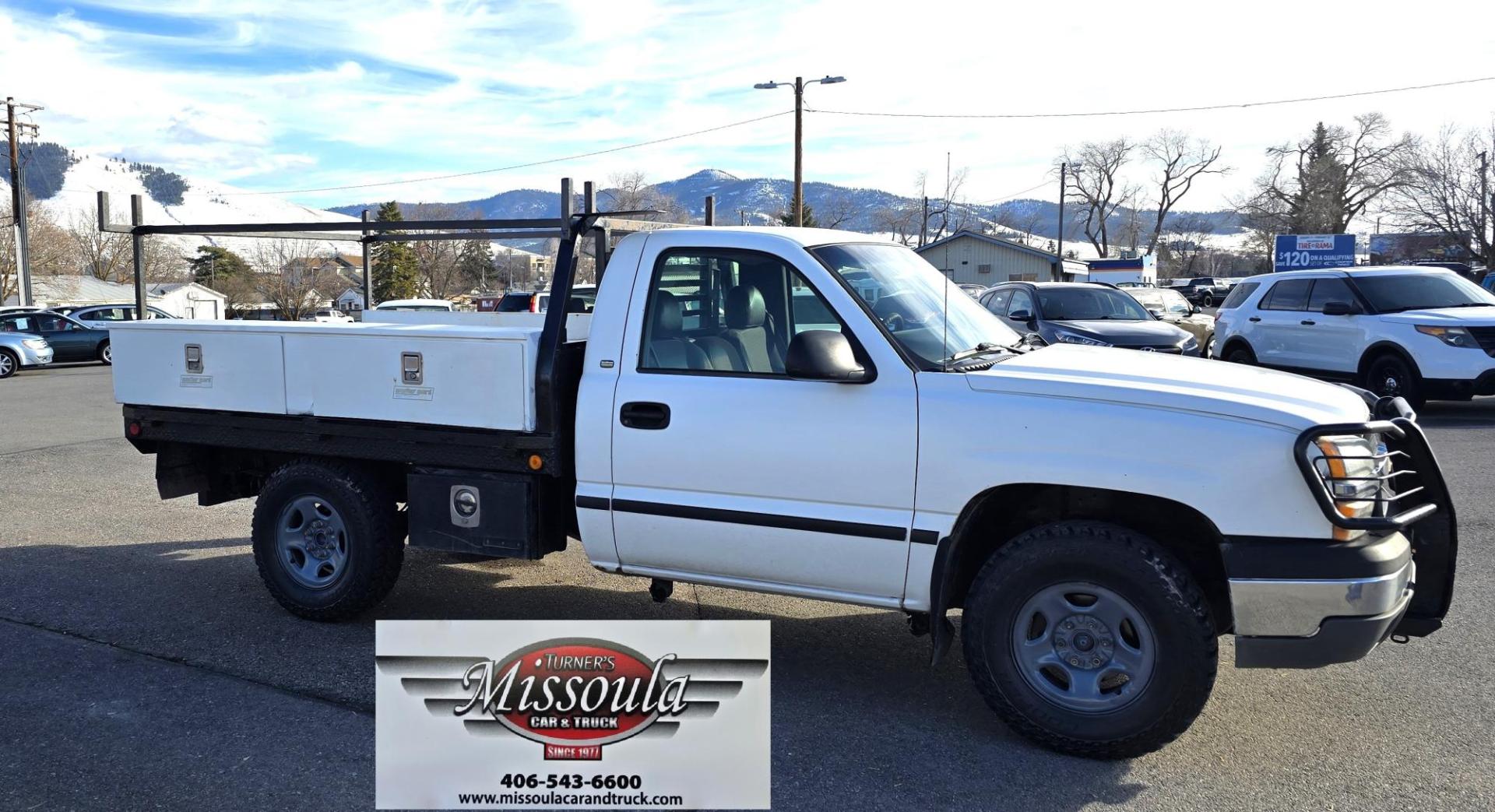 2003 White /Gray Chevrolet Silverado 1500 Long Bed 4WD (1GCEK14X73Z) with an 4.3L V6 OHV 12V engine, Automatic transmission, located at 450 N Russell, Missoula, MT, 59801, (406) 543-6600, 46.874496, -114.017433 - Work Truck that's ready for you.Strong Running 4.3 V6 Engine. 4WD. Automatic. Nice Flatbed with Tool Boxes on the side. Ladder / Lumber Rack. Gooseneck ball. Heavy Duty Rear Bumper for towing. Front Grill Guard. Air.Conditioning. Good Cooper Tires. Financing is NOT Available. - Photo#0